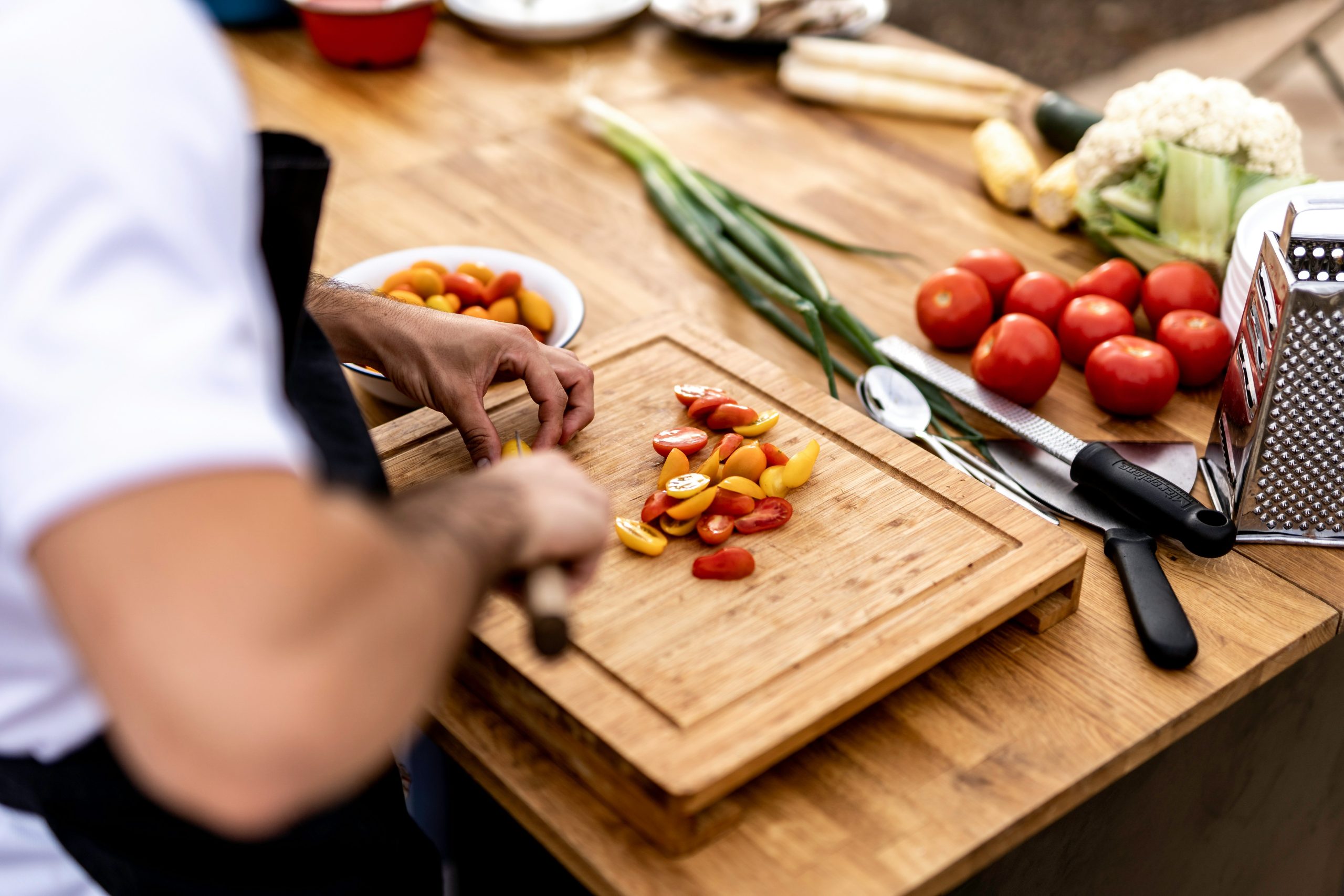 chef cutting vegetables on cutting board to uniform sizes. Photo by <a href="https://unsplash.com/@orhakim?utm_content=creditCopyText&utm_medium=referral&utm_source=unsplash">Or Hakim</a> on <a href="https://unsplash.com/photos/a-person-cutting-up-vegetables-on-a-cutting-board-S2Eql9vHN3o?utm_content=creditCopyText&utm_medium=referral&utm_source=unsplash">Unsplash</a><br />
      
